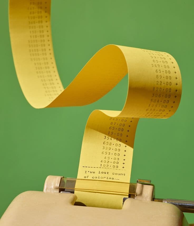 this is an image of a billing machine of the best content marketing companies from which a bill is rolling out. The machine is in beige color and the bill is in yellow color with a green background.